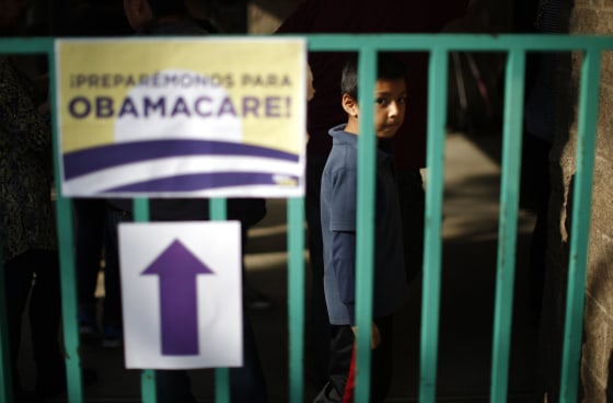 A boy waits in line at a health insurance enrollment event in Cudahy, California March 27, 2014.