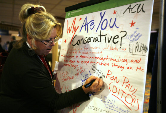 A woman signs a "Why are you a Conservative" message board at the Conservative Political Action conference (CPAC) in Washington February 10, 2011.