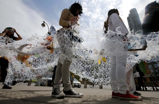 Demonstrators march together in plastic six-pack rings during a demonstration to mark Earth Day in Manhattan in New York City on April 22. Members of the Oragami Project, a movement that encourages environmental responsibility by transforming plastic six pack rings into wearable art, demonstrated "trapped" in the plastic six pack rings to symbolize birds and and other wildlife caught in trash. The global theme for the 2014 Earth Day is Green Cities.