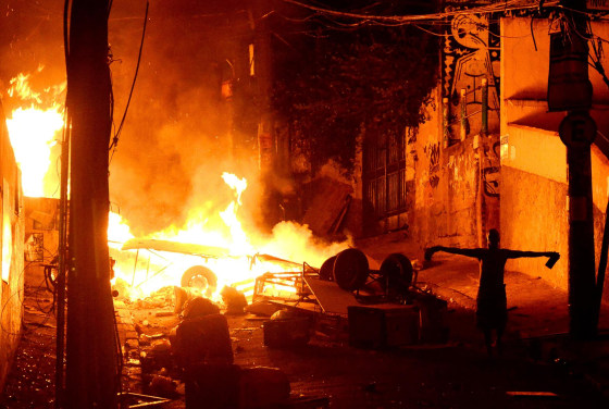Image: A resident gestures during a protest against the death of a man in Pavao-Pavaozinho slum, in the Copacabana neighborhood in Rio de Janeiro