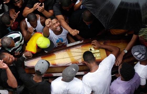 Image: Relatives and friends of Douglas Rafael da Silva Pereira, 25, mourn during his burial in Rio de Janeiro