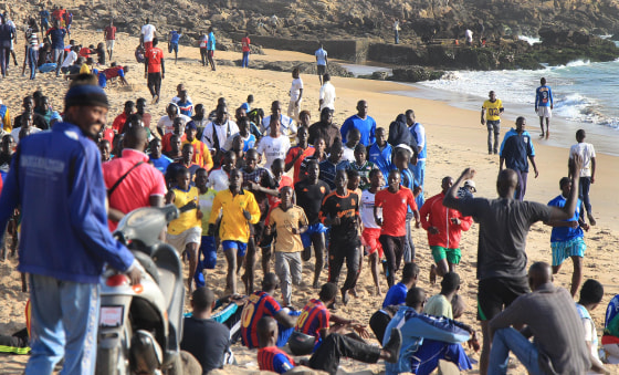 Men and boys work out on the beach in Dakar, Senegal.