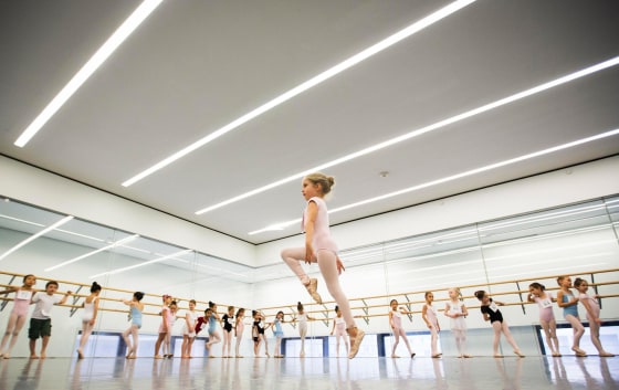 Image: Children watch as a girl dances during an audition for the School of American Ballet in New York
