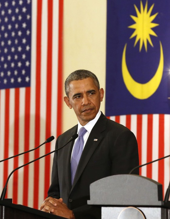 President Barack Obama listens to Malaysian Prime Minister Najib Razak speak in Putrajaya, Malaysia, on Sunday.