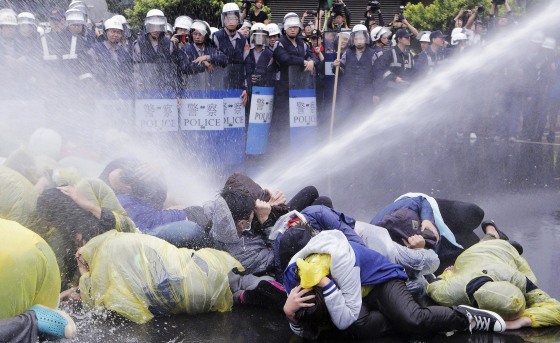 Police use a water cannon to disperse demonstrators protesting the construction of a fourth nuclear plant, in front of Taipei Railway station in Taipei April 28, 2014.