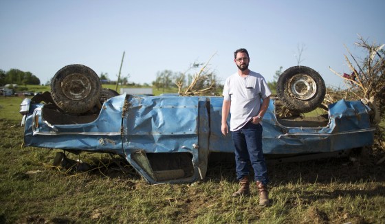 Image: Wade Lentz stands next to his wrecked 1980 Chevy Silverado in Vilonia, Ark.