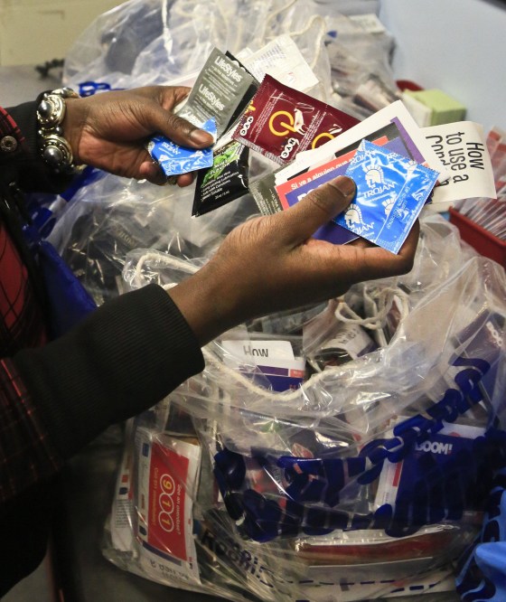 J. Starks, an outreach worker at Boom Health center, package condoms for distribution to sex trade workers, Friday April 25, 2014 in Bronx, N.Y. City police are allowed to confiscate those very condoms as evidence of prostitution, yet New York City spends more than a million dollars every year to distribute free condoms to combat unintended pregnancies and diseases. That conflict is behind the latest legislative proposal to prohibit condoms from being used as evidence in prostitution cases. 