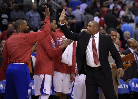 Los Angeles Clippers head coach Doc Rivers, right, congratulates members of his team during the second half in Game 5 of an opening-round NBA basketball playoff series against the Golden State Warriors, Tuesday, in Los Angeles. The Clippers won 113-103.