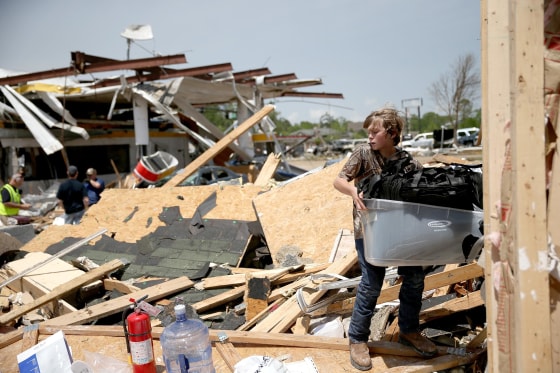 Image: Sam Smith helps a family friend salvage what he can from his business that was destroyed by a tornado on April 29, 2014 in Tupelo, Miss.