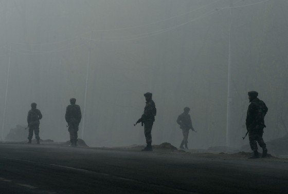 Image: Indian army soldiers patrol along a roadside amongst heavy fog outside a polling station
