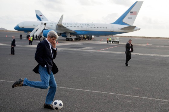U.S. Secretary of State John Kerry kicks a soccer ball around during an airplane refueling stop at Sal Island, Cape Verde, on May 5, 2014.