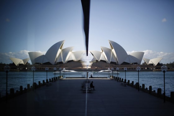Image: The Sydney Opera House is reflected in a harbourside hotel window in The Rocks district of Sydney