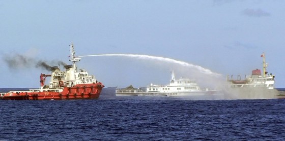 Image: Chinese ship, left, shoots water Wednesday at a Vietnamese vessel