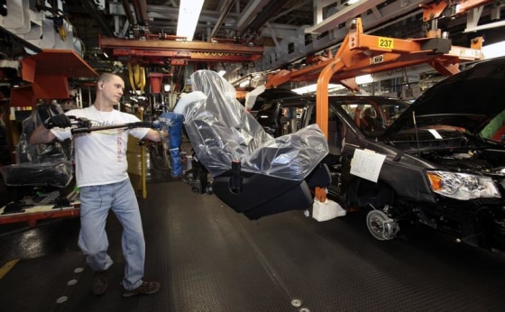 A Chrysler auto worker load the seats into Chrysler minivans during the production launch of the new 2011 Dodge and Chrysler minivans at the Windsor Assembly Plant