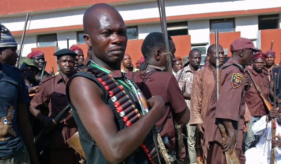 Armed hunters gather before looking for around 300 abducted school girls in Maiduguri, Nigeria on May 18, 2014. Hundreds of hunters armed with homemade rifles, poisoned arrows and amulets say their spiritual powers can lead them to the nearly 300 schoolgirls abducted by Islamic extremists.