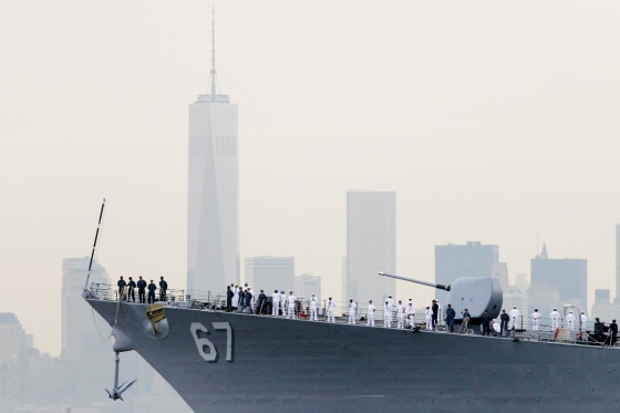 Image: Sailors line the bow of the destroyer USS Cole as it glides past One World Trade Center
