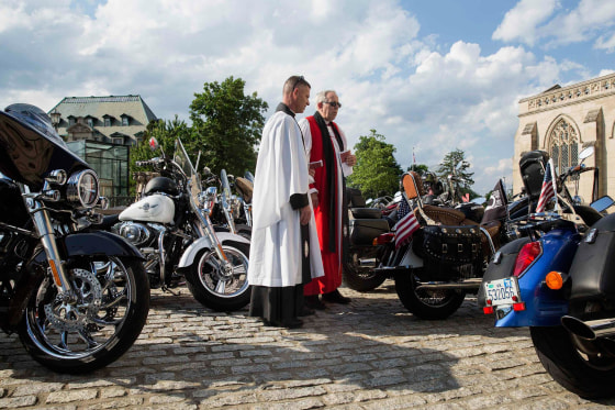 Image: Members of the Episcopal Church before the 'Blessing of the Bikes' ceremony at the National Cathedral in Washington