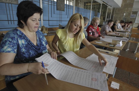 Image: Members of Ukraine's Election Commission prepare for voters