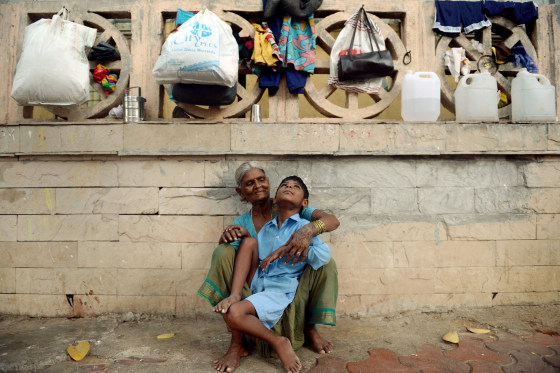 Image: Indian boy Lakhan Kale sits with his grandmother on the pavement in Mumbai