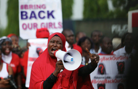 Image: A protester addresses the \"Bring Back Our Girls\" protest group as they march to the presidential villa