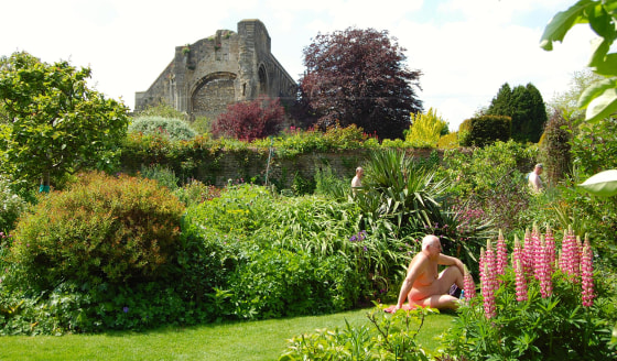 Nudists relax at Abbey House Gardens in Malmesbury, U.K.