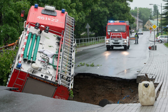 A fire truck fell into a cavity that opened up in a road after heavy overnight rain in Glucholazy, in lower Silesia, Poland, on May 29, 2014.