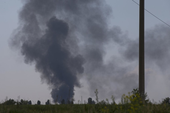 Image: Black smoke rises from a shot down Ukrainian Army helicopter outside Slovyansk