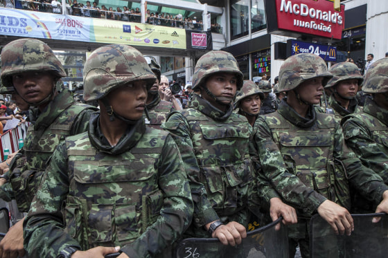 Image: Soldiers stand guard as anti-coup protesters rally in Bangkok, Thailand