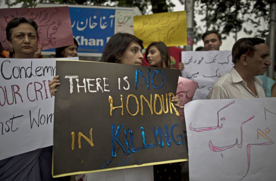Image: Protesters hold banners condemning the killing of Farzana Iqbal