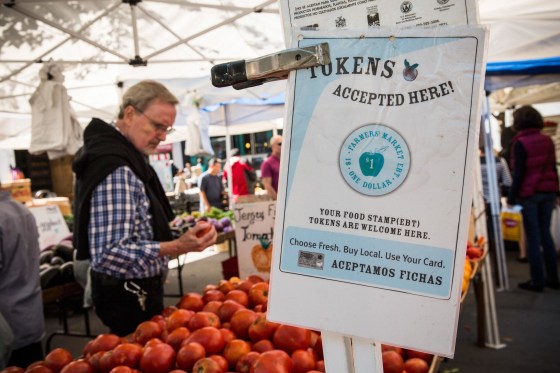 A sign displays that a shop accepts Electronic Benefits Transfer, commonly known as Food Stamps, in the GrowNYC Greenmarket in New York City. As the lingering impact of the Great Recession slowly recedes, so are the numbers of American families who rely on government help to put food on the table. 