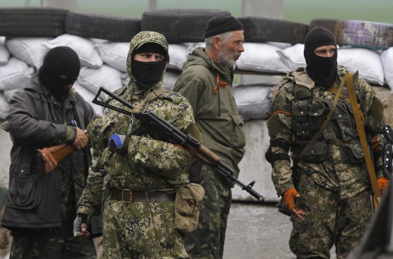 Pro-Russian masked armed militants guard barricades near Slovyansk, eastern Ukraine, on April 30, 2014.