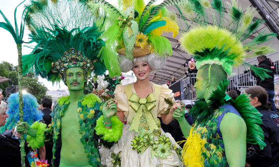 Image: Guests wear fancy costumes before the opening ceremony of the 'Life Ball 2014' in front of the City Hall in Vienna, Austria