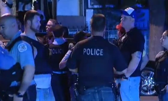 Image: Police stand near the scene of a shooting in Chicago.