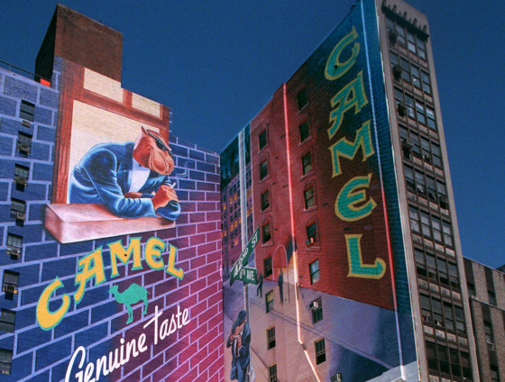 A Joe Camel advertisement is visible above New York's Times Square at 42nd Street and 8th Avenue in 1997.