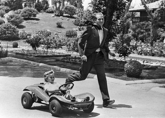 Image: Prince Juan Carlos of Spain playing with his son Don Felipe