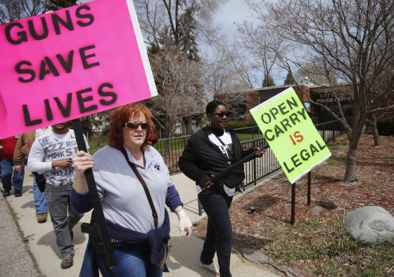 Image: Tammi Warren wears her pistol strapped to her hip during an Open Carry Gun supporters rally in front of the Romulus Police Department in Romulus