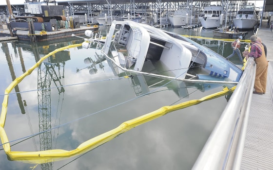 A yacht sits on its side on May 19 near Anacortes, Wash.