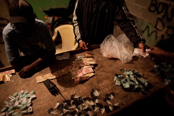 Image: Traffickers sell drugs in the Antares slum in Rio de Janeiro