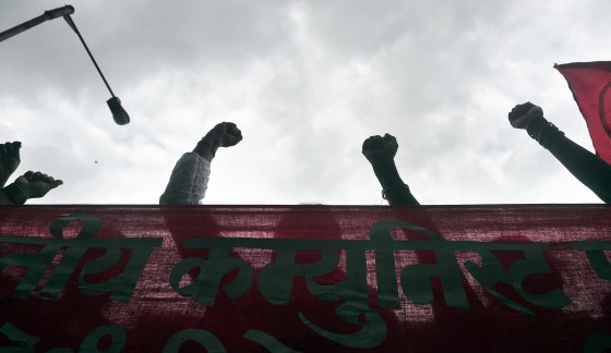 Image: Indian demonstrators raise clenthed fists as they protest the killing of a leading Indian anti-superstition activist on Aug. 21, 2013