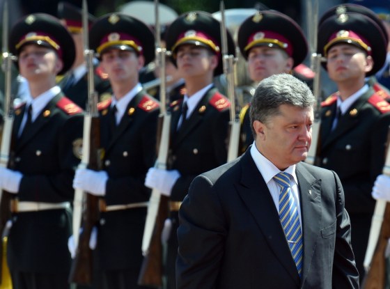 Ukraine's President Petro Poroshenko walks in front of the guard of honor during a ceremony of his inauguration in Kiev on June 7, 2014. Petro Poroshenko was sworn in as Ukraine's fifth post-Soviet president today, vowing to maintain the unity of his country amid a continuing crisis with Russia. Poroshenko, a 48-year-old billionaire who won the presidential election on May 25 with 54.7 percent of the vote, took the oath in the Ukrainian parliament in Kiev.