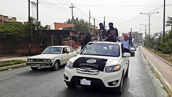 Image: Fighters of the Islamic State of Iraq and the Levant (ISIL) celebrate on vehicles taken from Iraqi security forces, at a street in city of Mosul