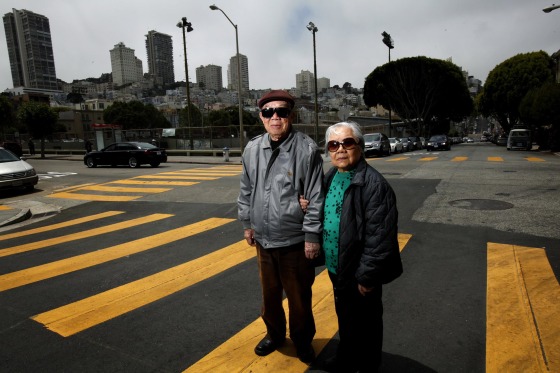 Image: Jian Zhong Li, 92, and his wife Lew Ching Gee Li, 89, are photographed on their block in the North Beach neighborhood in San Francisco, Calif.