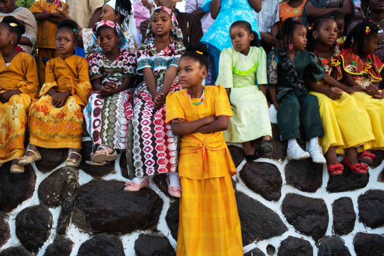 Image: Members of the African Hebrew Israelite community watch a dance as they take part in celebrations for the holiday of Shavuot in Dimona