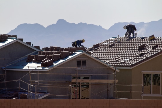 Roofers work on new homes at a residential construction site in the west side of the Las Vegas Valley.
