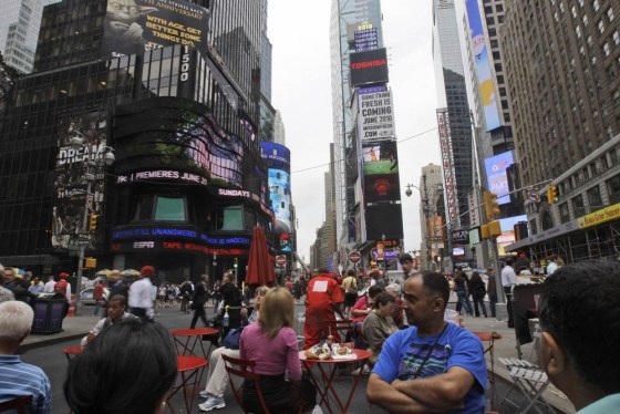 Image: People frequent pedestrian plazas in Times Square/Herald Square in New York.