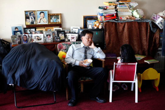 Alan Choy chats with his daughter Yvania, 8, about her day at their home in San Francisco, on June 17, 2014. The Choys, who receive Social Security Disability Insurance, are struggling financially.