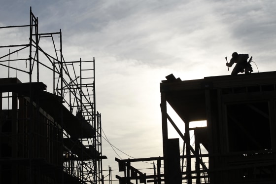 Image: File photo of a worker on the roof of a building under construction in Los Angeles