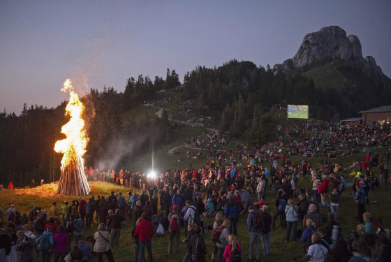 Image: People watch World Cup match between Germany and Ghana during the Sonnwendfeuer Festival at Mt. Kampenwand