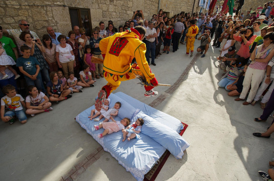 A man representing the devil leaps over babies during the festival of El Salto del Colacho (the devil's jump) on June 22, 2014 in Castrillo de Murcia, Spain. The festival, held on the first Sunday after Corpus Christi, is a catholic rite of the devil cleansing babies of original sin.