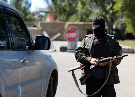 Image: A Russian separatist controls a car on the checkpoint in Sloviansk, Ukraine